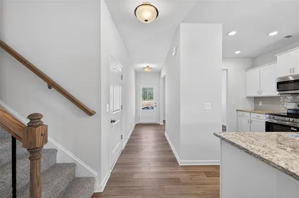 a large kitchen with lots of counter space wooden floor and appliances