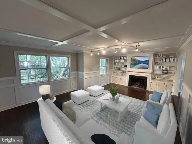 a living room with furniture a fireplace and a large window