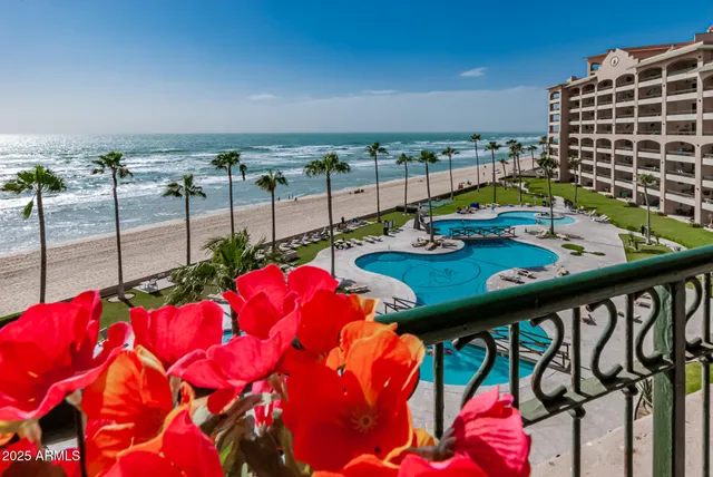a balcony with chairs and table