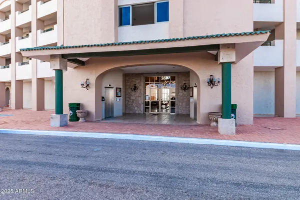 a dining room with wooden floor a chandelier a wooden table and chairs