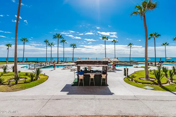 a view of a cafe with a table and chairs under an umbrella