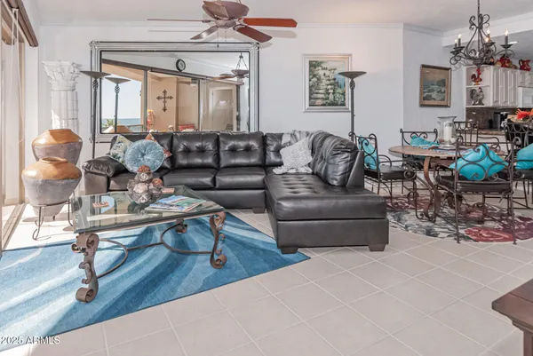 a living room with furniture and a chandelier