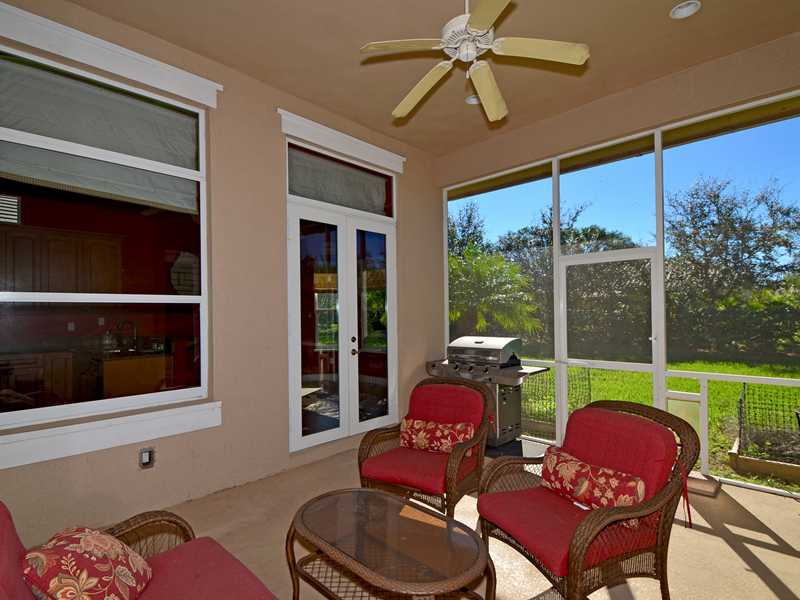 1185 River Wind Circle Vero Beach, FL 32967 - Photo 14 of 29 a living room with furniture and a floor to ceiling window