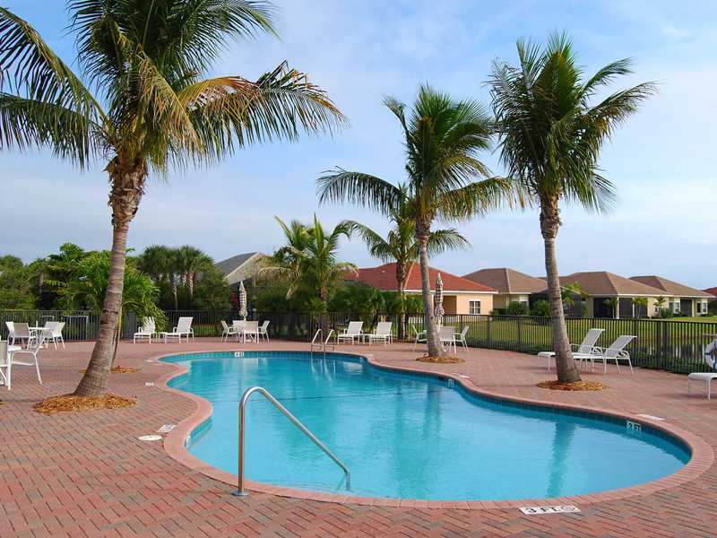 1185 River Wind Circle Vero Beach, FL 32967 - Photo 17 of 29 a view of a swimming pool with a patio and palm tree