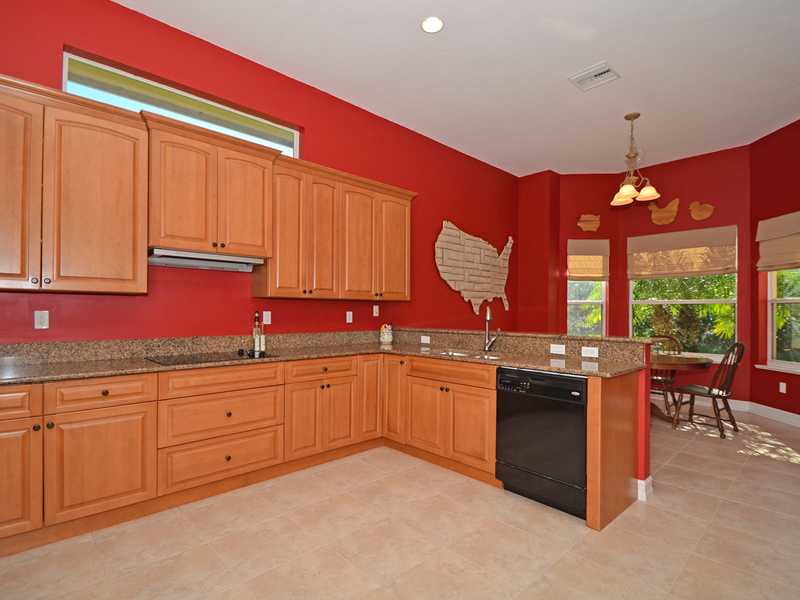 1185 River Wind Circle Vero Beach, FL 32967 - Photo 5 of 29 a kitchen with granite countertop a sink stove and cabinets