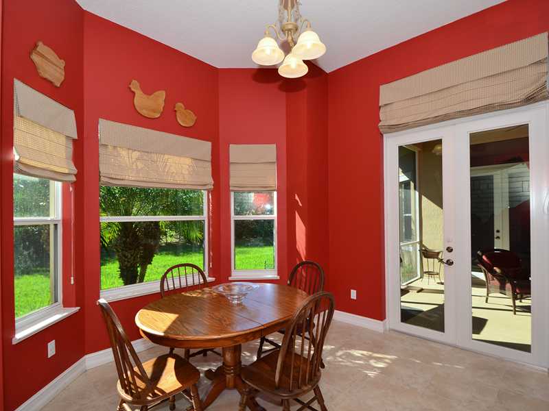 1185 River Wind Circle Vero Beach, FL 32967 - Photo 7 of 29 a dining room with furniture a large window and a chandelier