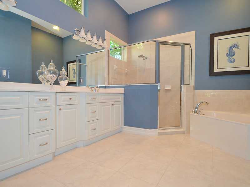 1185 River Wind Circle Vero Beach, FL 32967 - Photo 10 of 29 a bathroom with a tub sink and mirror