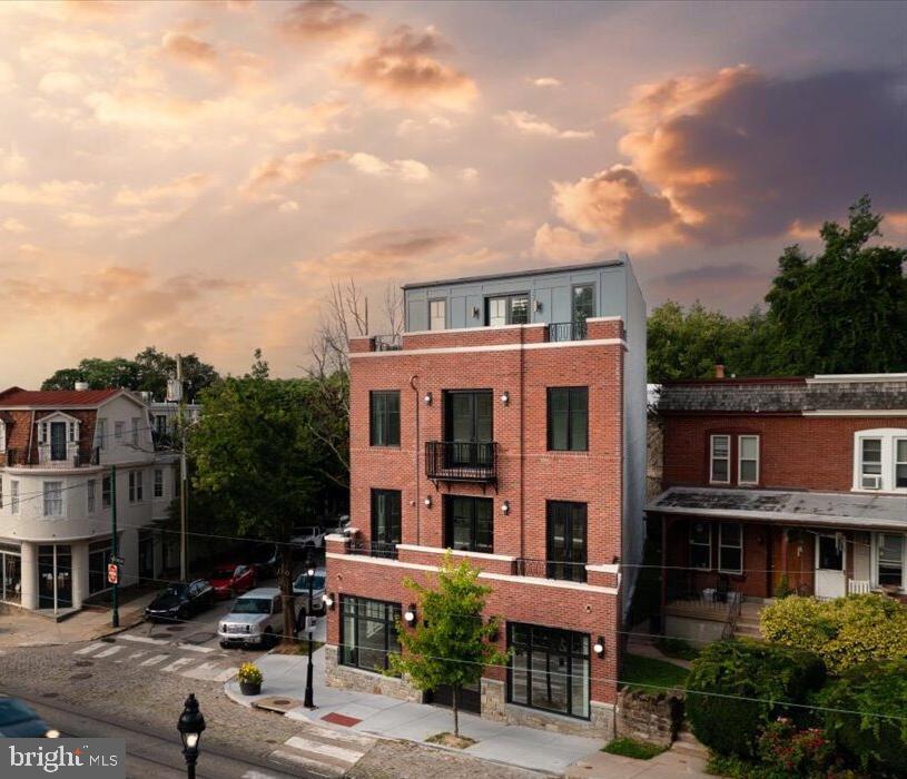 a front view of a residential apartment building with a yard