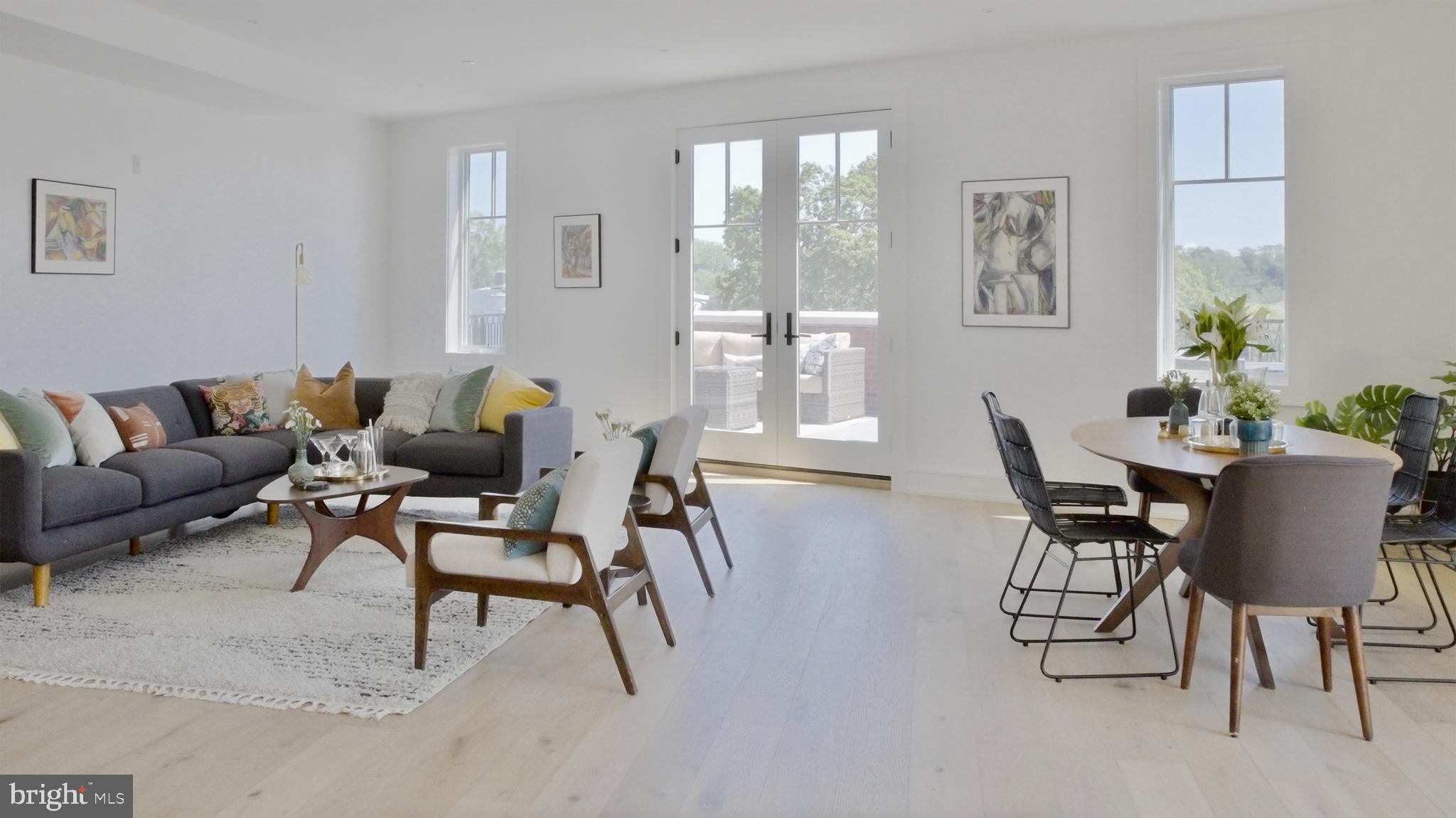 8100 Germantown Avenue, Unit B Philadelphia, PA 19118 - Photo 3 of 13 a living room with furniture and a potted plant