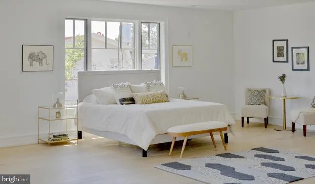 a bedroom with a bed and a table chair