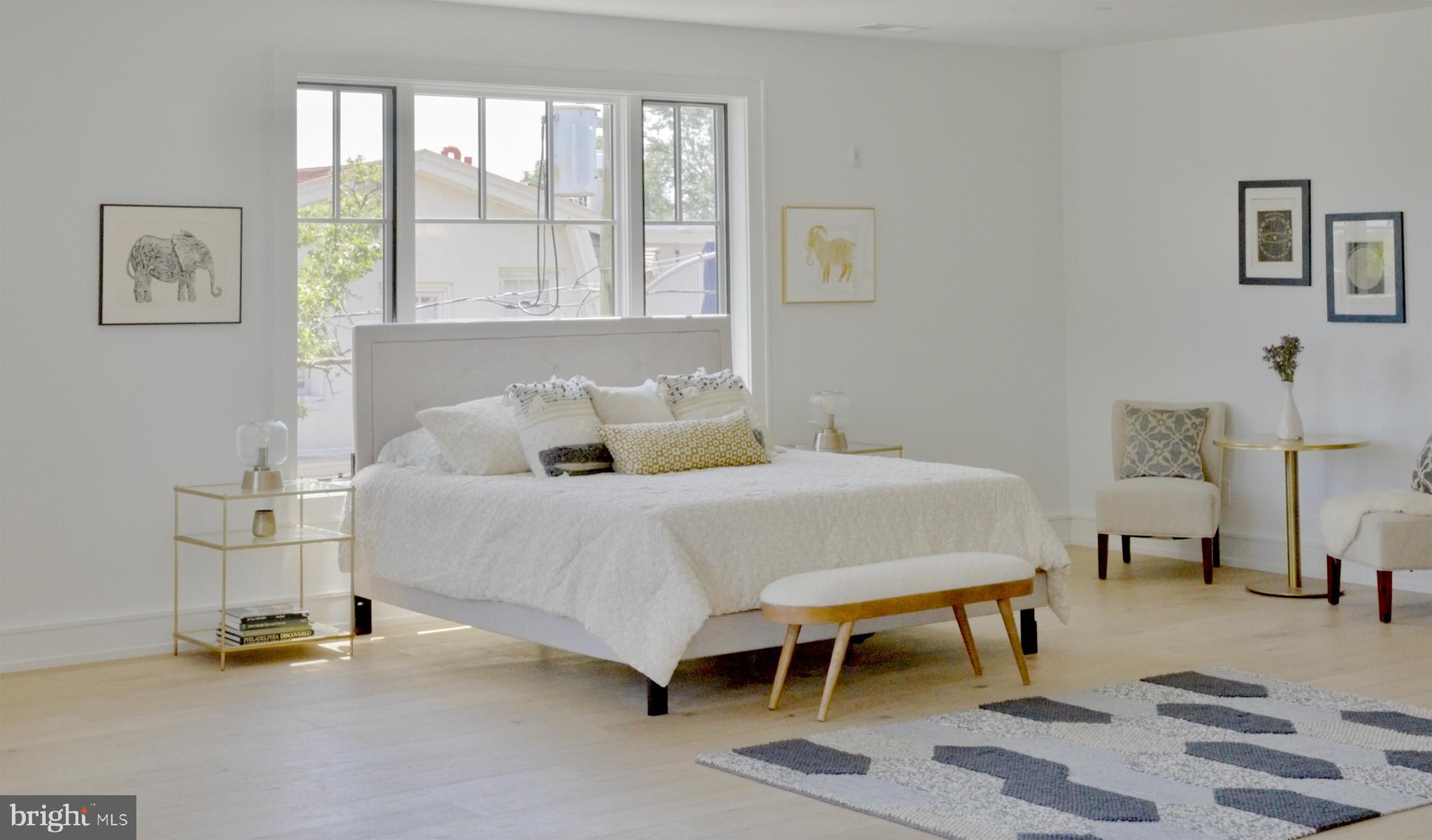 8100 Germantown Avenue, Unit B Philadelphia, PA 19118 - Photo 9 of 13 a bedroom with a bed and a table chair