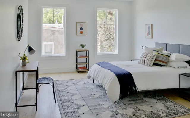 a bedroom with a bed and a window