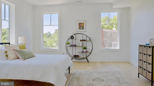 a view of a bedroom with a bed and a window