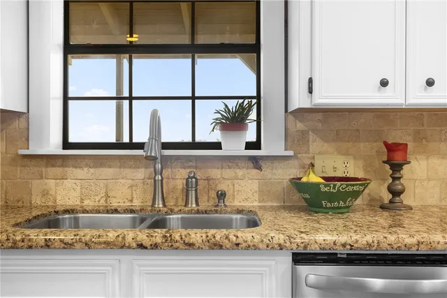 a kitchen with a stove and window