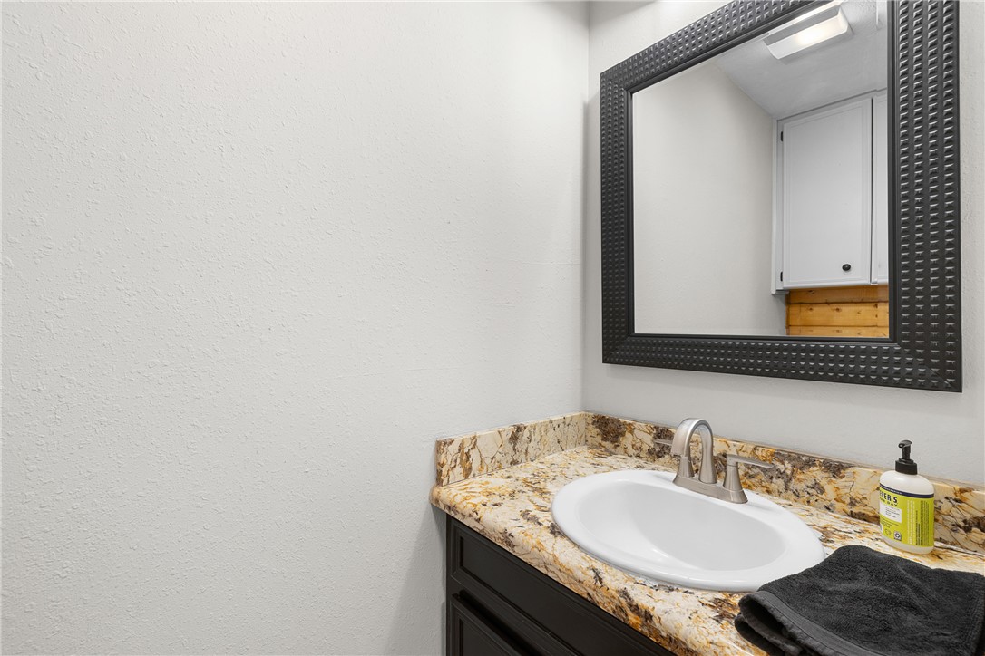 11867 Farm To Market 2159 Calvert, TX 77837 - Photo 13 of 41 a bathroom with a granite countertop sink and a mirror