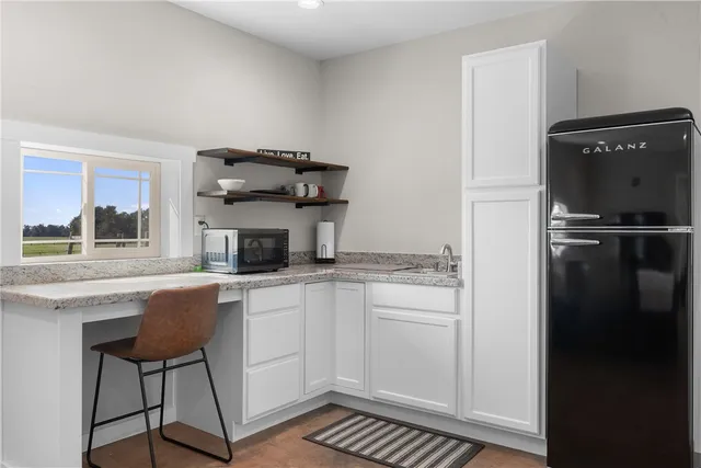 a kitchen with stainless steel appliances granite countertop a stove a refrigerator and a microwave