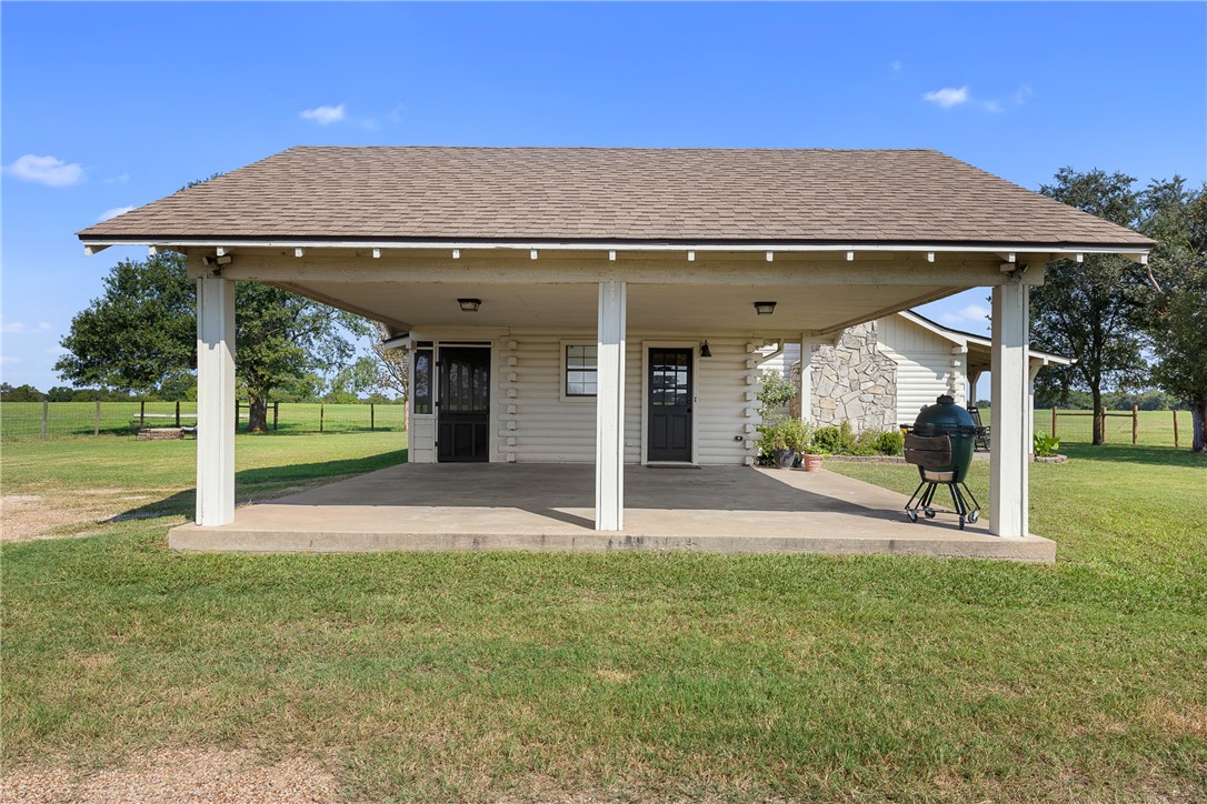 11867 Farm To Market 2159 Calvert, TX 77837 - Photo 5 of 41 a patio with a table and chairs under an umbrella