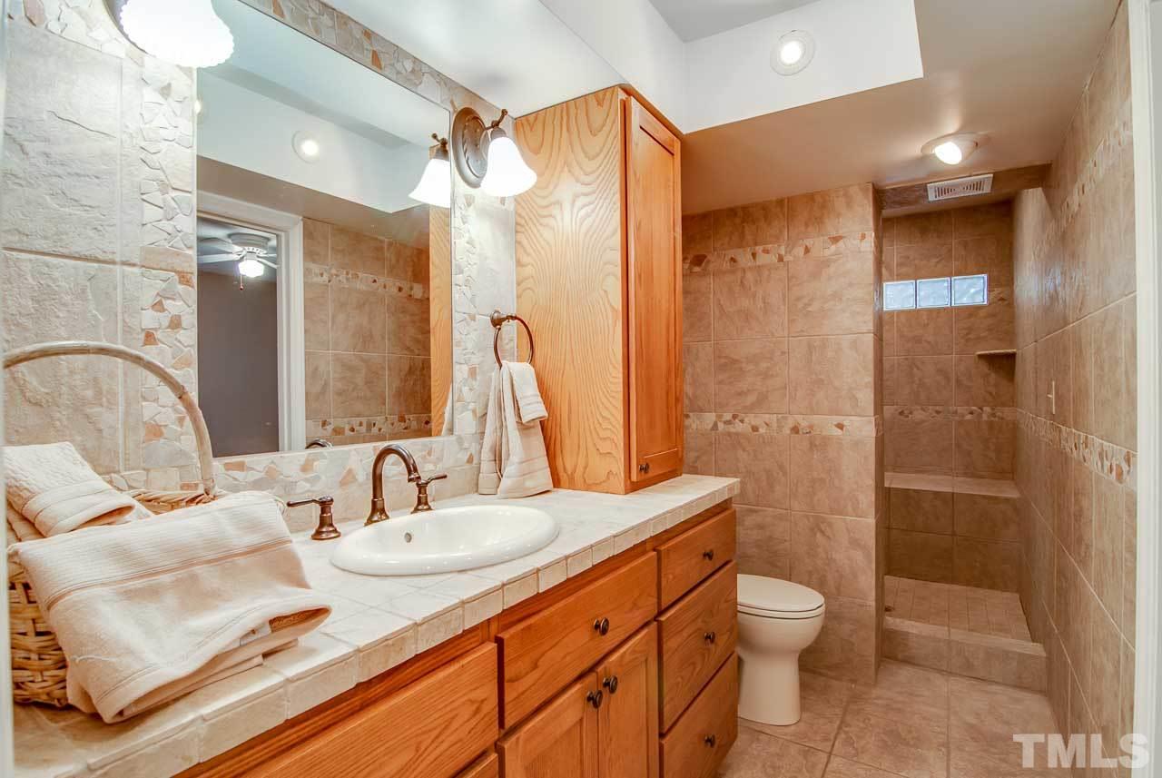 4620 Jimmy Rogers Road Durham, NC 27704 - Photo 13 of 25 a bathroom with a sink and a mirror