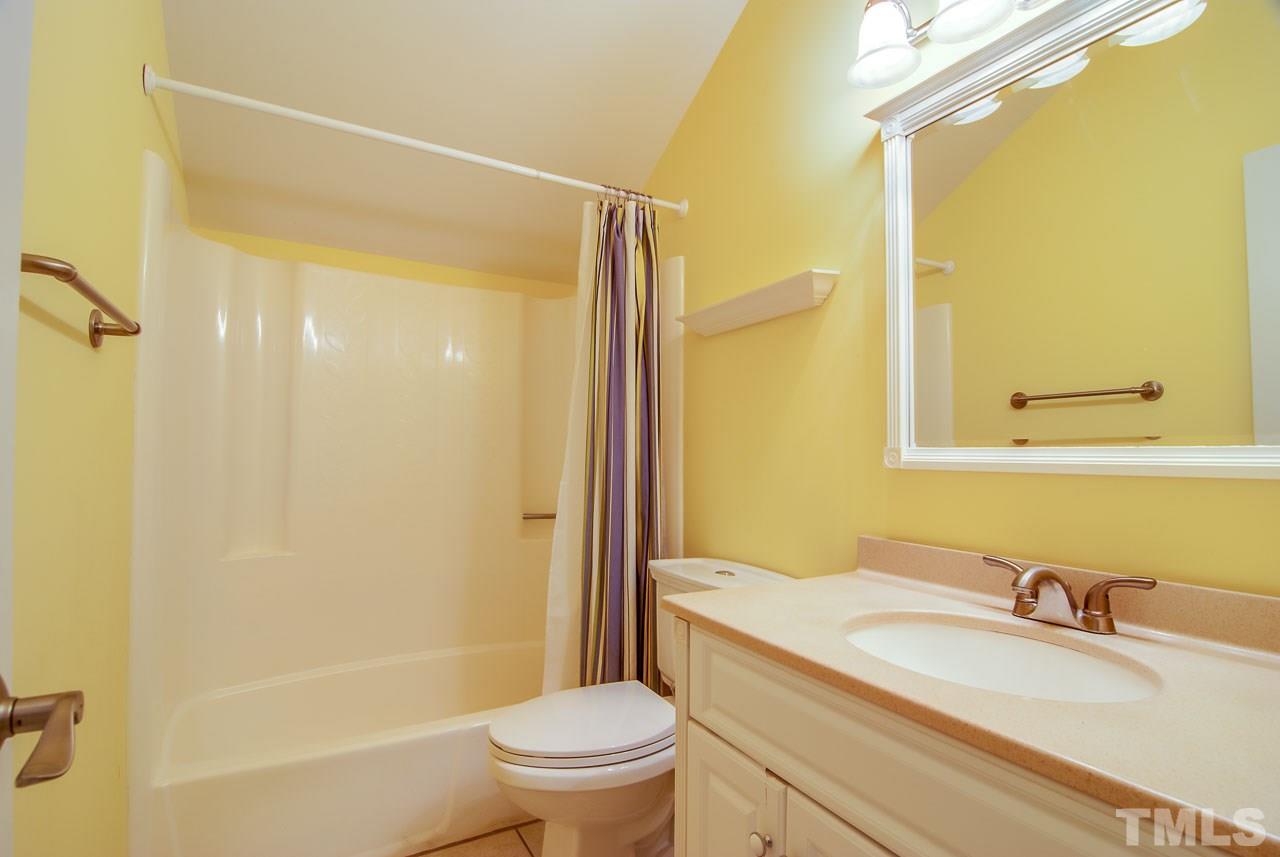 4620 Jimmy Rogers Road Durham, NC 27704 - Photo 19 of 25 a bathroom with a granite countertop sink toilet and shower
