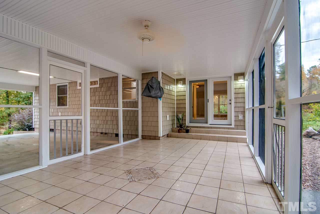 4620 Jimmy Rogers Road Durham, NC 27704 - Photo 21 of 25 a view of empty room with wooden floor and fan