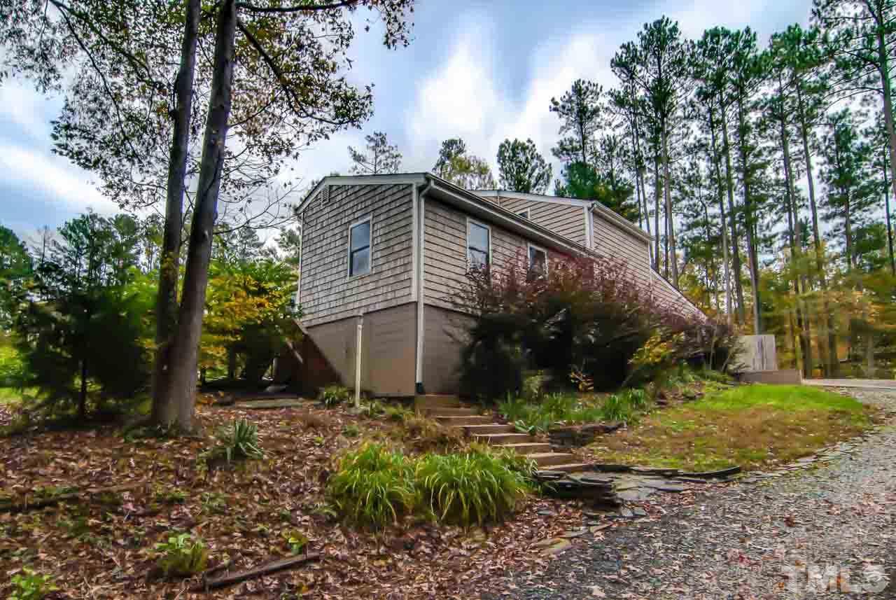 4620 Jimmy Rogers Road Durham, NC 27704 - Photo 22 of 25 a backyard of a house with lots of green space