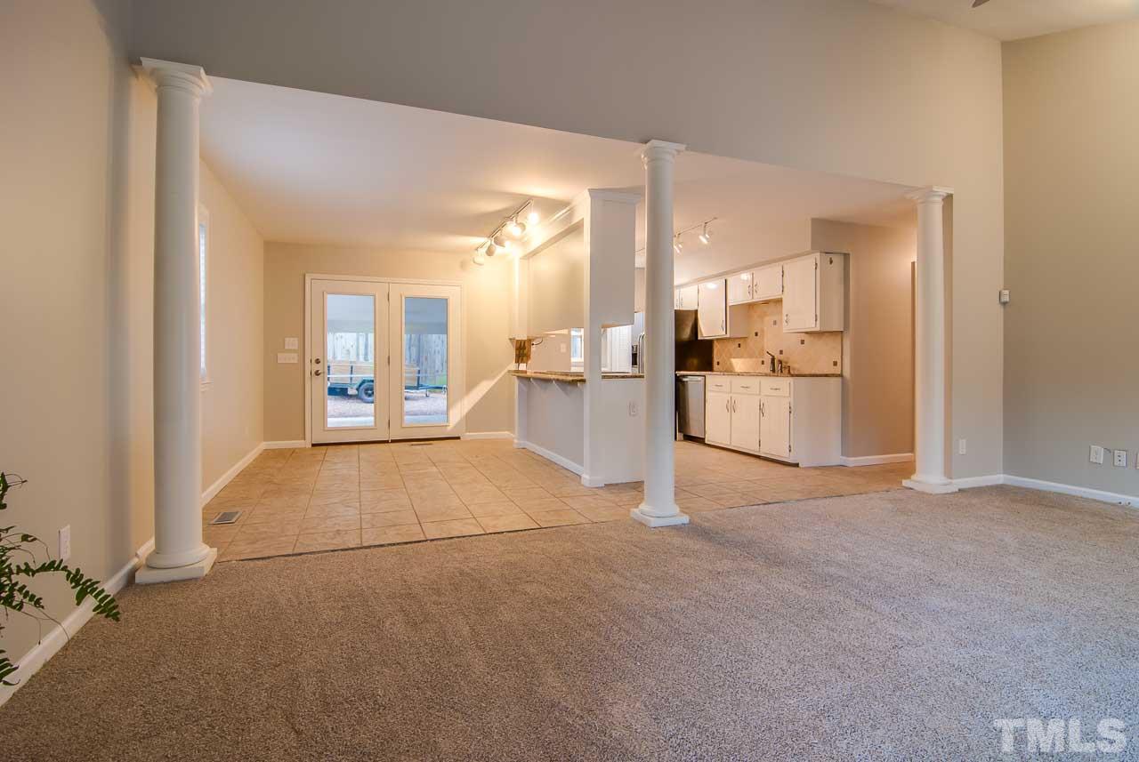 4620 Jimmy Rogers Road Durham, NC 27704 - Photo 5 of 25 a view of a kitchen with refrigerator and white cabinets
