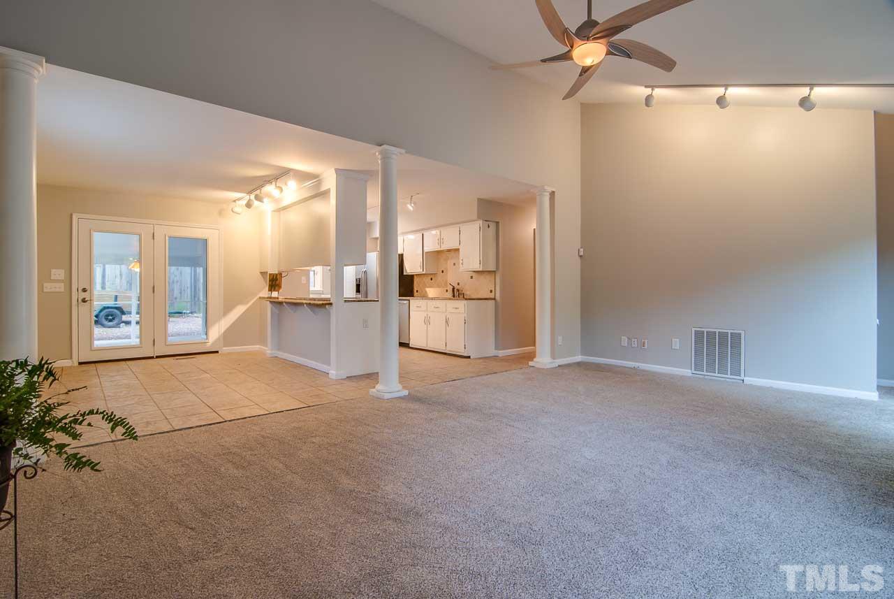4620 Jimmy Rogers Road Durham, NC 27704 - Photo 6 of 25 an empty room with a cabinet and mirrors