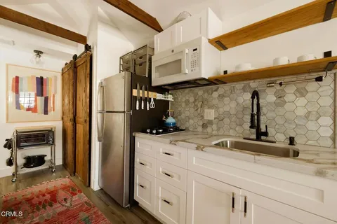 a kitchen with stainless steel appliances a sink and a refrigerator