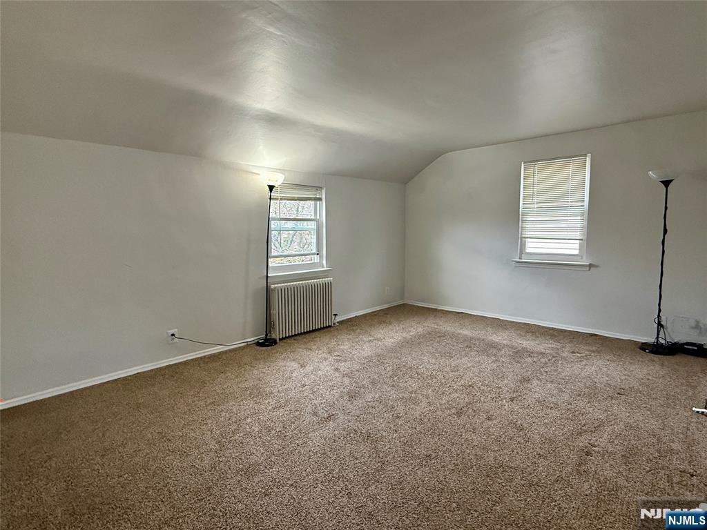 47 MacArthur Avenue, Unit 2 Lodi, NJ 07644 - Photo 2 of 6 an empty room with windows