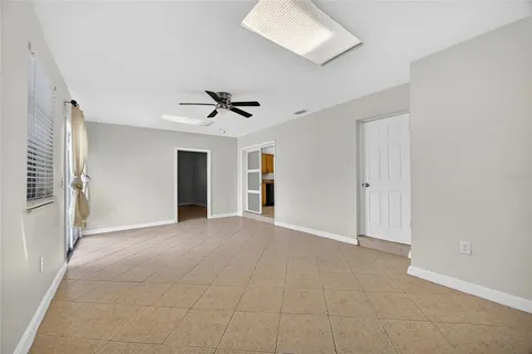 a view of an empty room with a ceiling fan