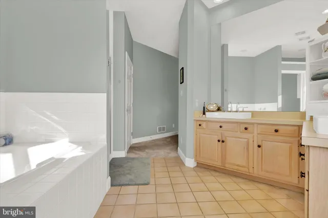 a spacious bathroom with a mirror sink and vanity