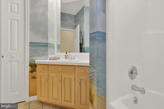 a bathroom with a sink a mirror and a bathtub