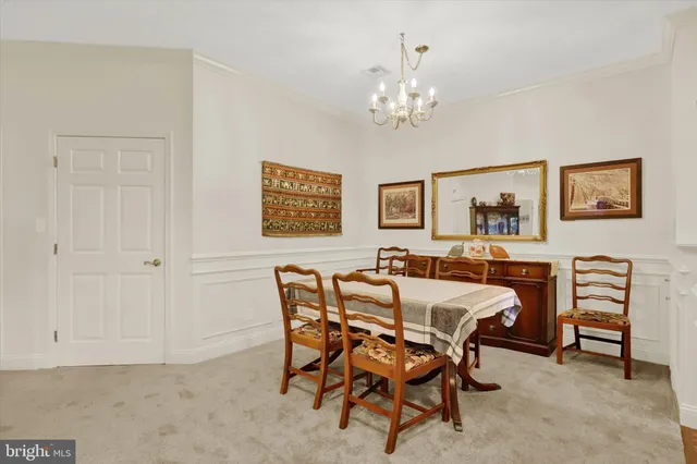 a dining room with furniture and chandelier