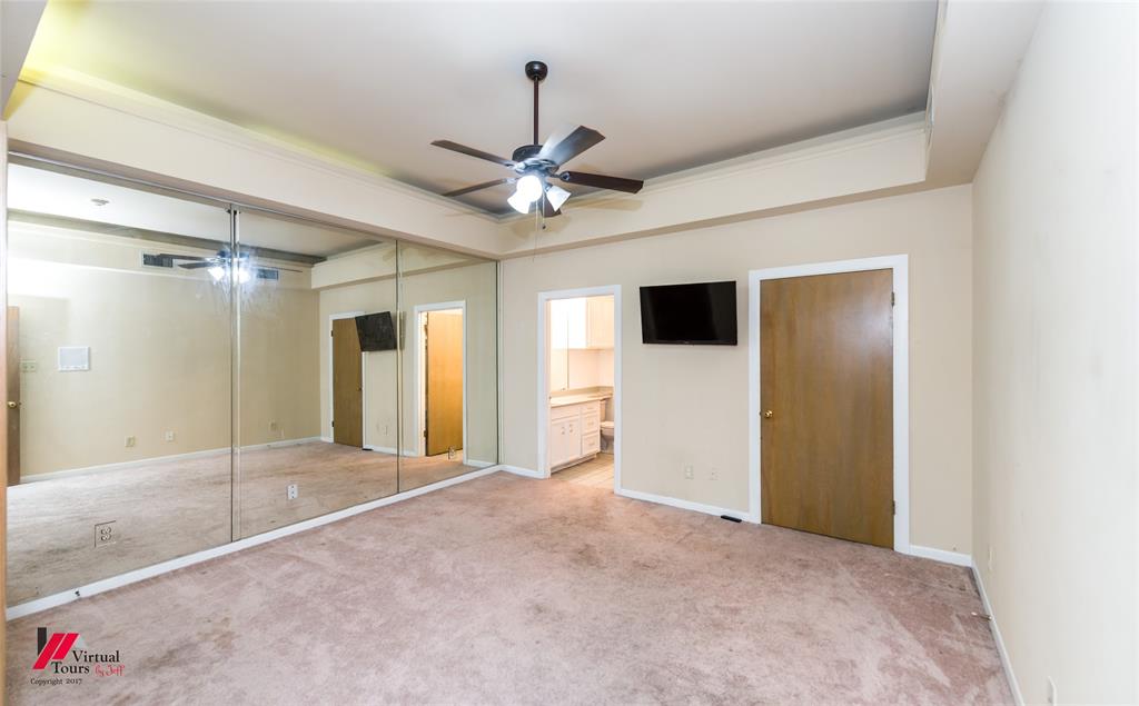 300 Pierremont Road, Unit 40 Shreveport, LA 71106 - Photo 8 of 34 Spacious remote bedroom featuring a mirrored wall, carpet flooring, ceiling fan, crown molding and private bath