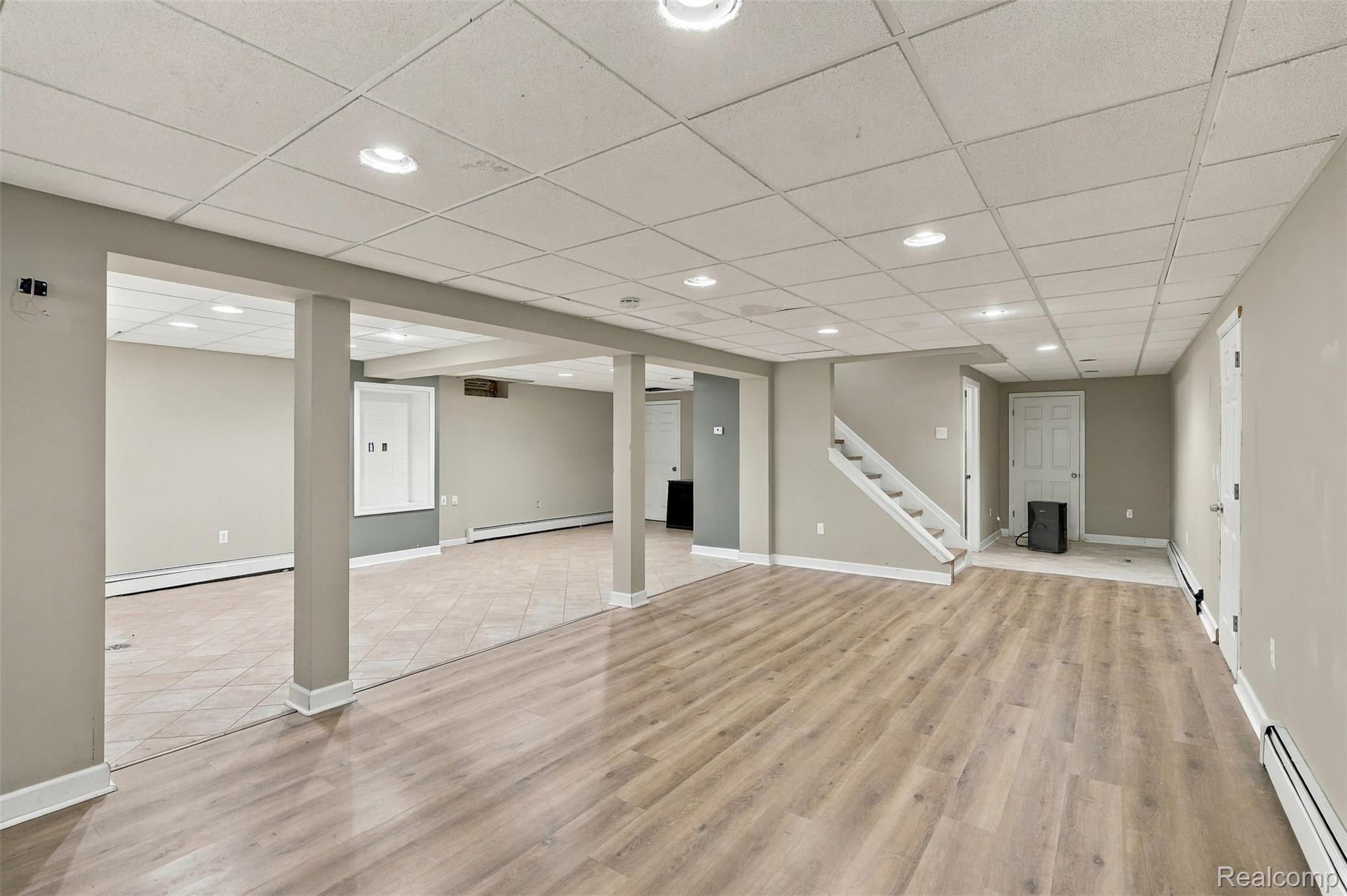 26516 Romine Road New Boston, MI 48164 - Photo 33 of 62 Spacious finished lower level featuring recessed lighting, wood-finish flooring, and a tiled area