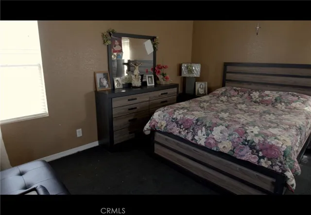 a bed sitting in a bedroom next to a window