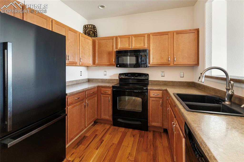 7309 Sandy Springs Point Fountain, CO 80817 - Photo 11 of 35 a kitchen with a sink a stove and cabinets
