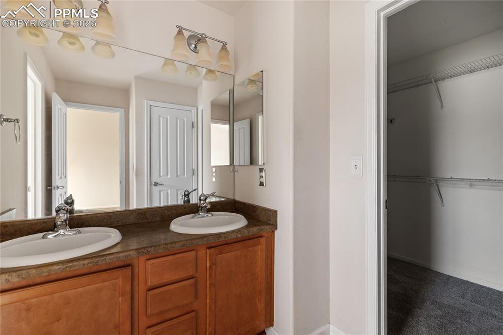7309 Sandy Springs Point Fountain, CO 80817 - Photo 12 of 35 a bathroom with a sink and a mirror