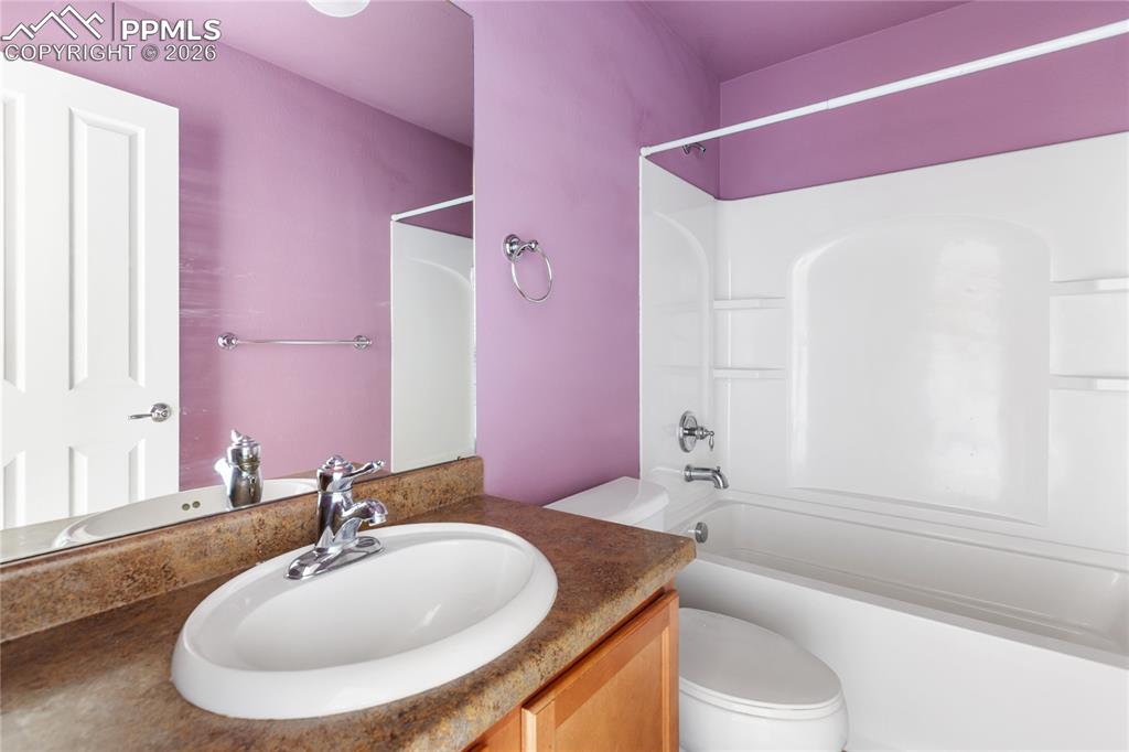 7309 Sandy Springs Point Fountain, CO 80817 - Photo 19 of 35 a bathroom with a granite countertop sink and a mirror
