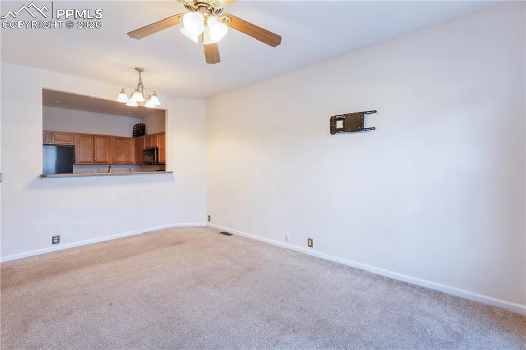 7309 Sandy Springs Point Fountain, CO 80817 - Photo 4 of 35 an empty room with a chandelier fan and windows