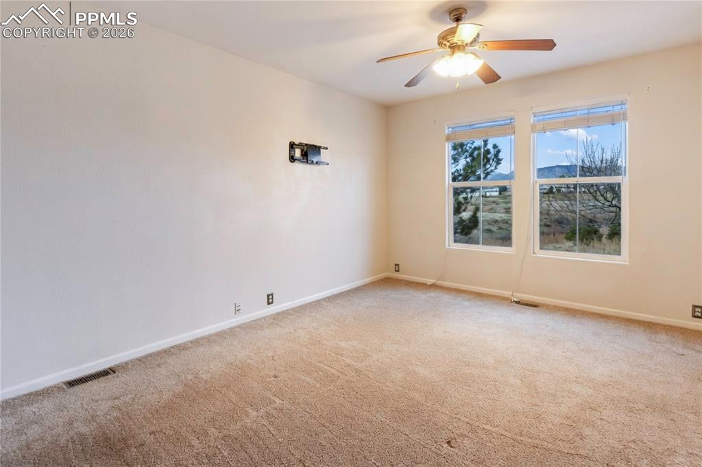 7309 Sandy Springs Point Fountain, CO 80817 - Photo 5 of 35 an empty room with windows and fan