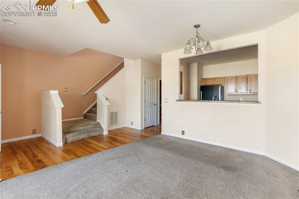 7309 Sandy Springs Point Fountain, CO 80817 - Photo 7 of 35 a view of a livingroom with wooden floor and a ceiling fan