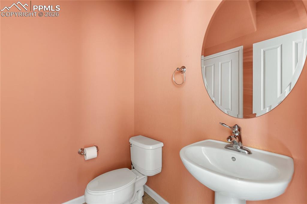 7309 Sandy Springs Point Fountain, CO 80817 - Photo 9 of 35 a bathroom with a toilet a sink and mirror