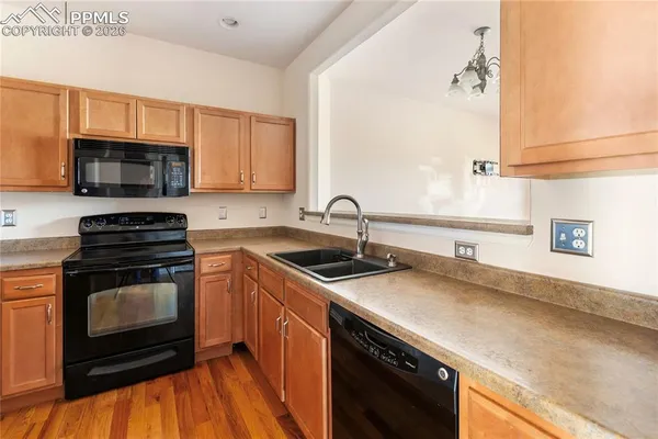 a kitchen with a sink stove and microwave