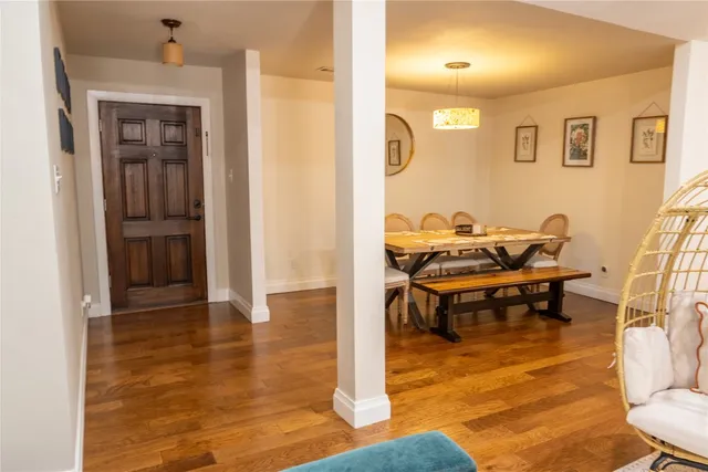 a living room with furniture and floor to ceiling windows