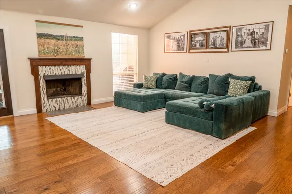 a living room with furniture and a fireplace