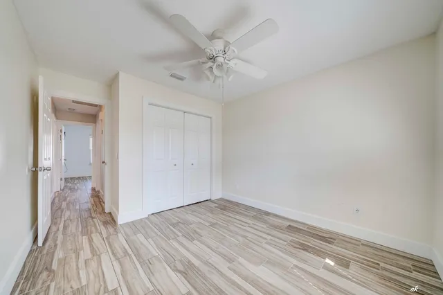 a view of a room with wooden floor