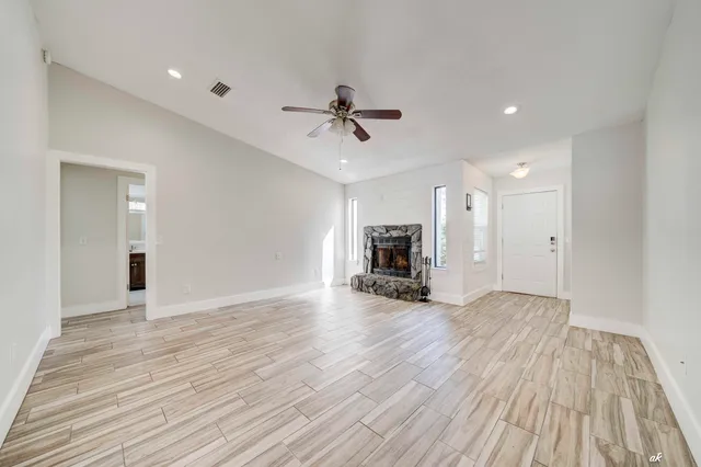 a view of a livingroom with a hardwood floor and a ceiling fan