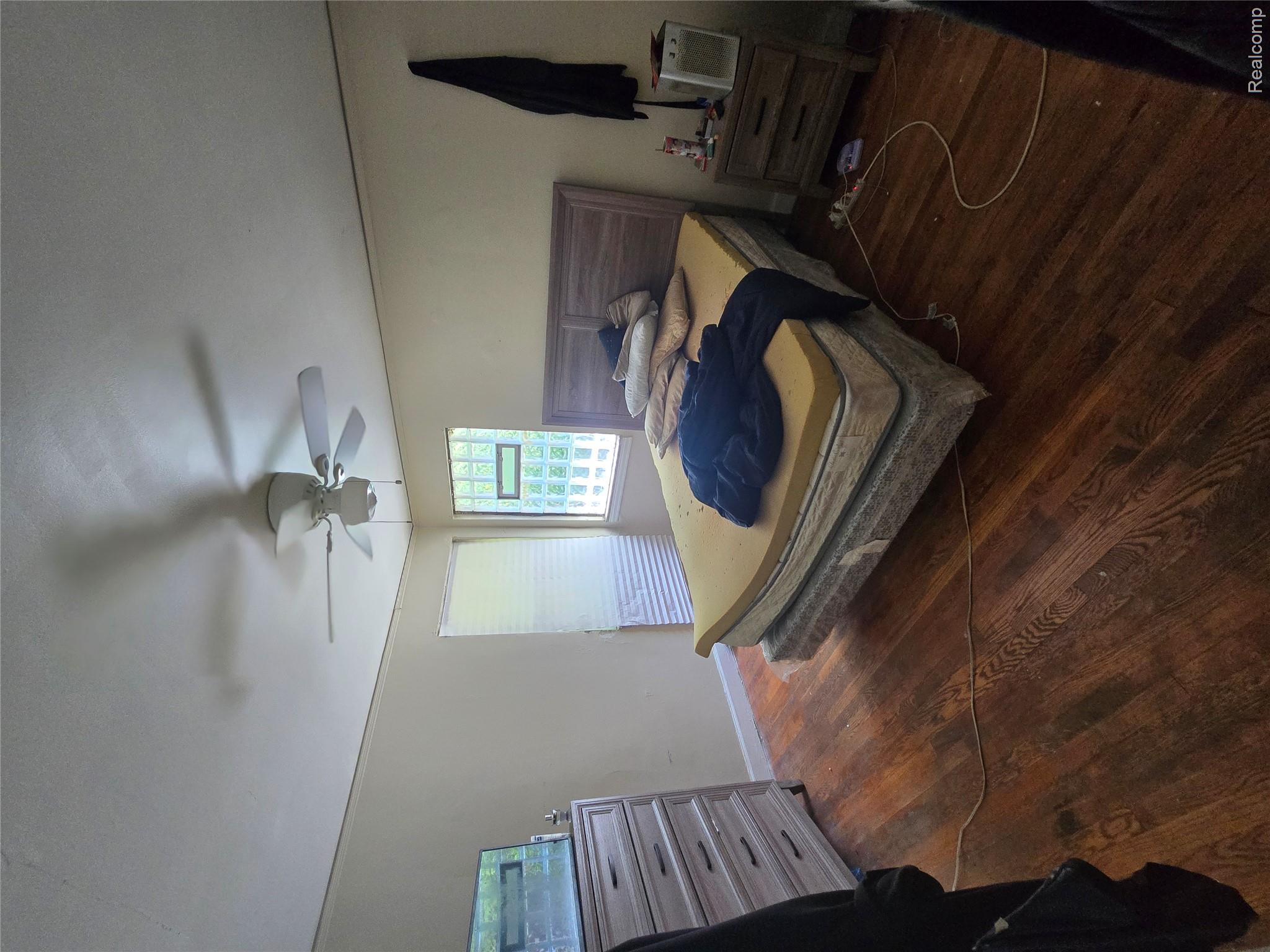 10342 Roxbury Street Detroit, MI 48224 - Photo 20 of 30 Wood-finish flooring with a ceiling fan, and window with privacy blinds