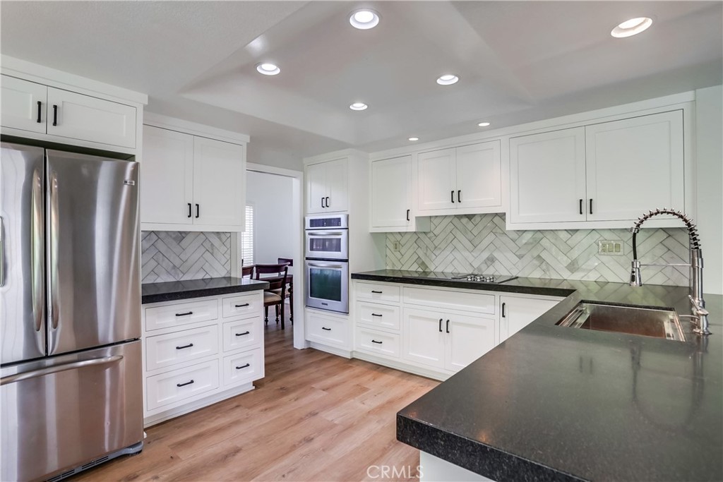 26511 Maside Mission Viejo, CA 92692 - Photo 11 of 46 a kitchen with stainless steel appliances granite countertop a refrigerator sink and cabinets